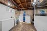Laundry area with unfinished concrete flooring and washer and dryer
