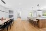Kitchen featuring hanging light fixtures, brown cabinetry, a breakfast bar area, a large island, and light wood-type flooring