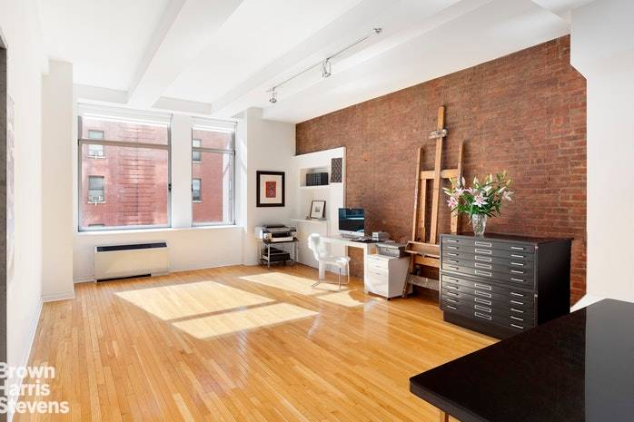 Sun flooded all day from extra large south facing windows in both rooms, a true loft with exposed brick walls, long oak plank floors, 11' ceilings, and tons of storage ...