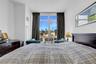 Bedroom featuring visible vents and a view of city