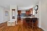 Modern kitchen featuring wood-finish flooring, recessed lighting, and stainless steel appliances