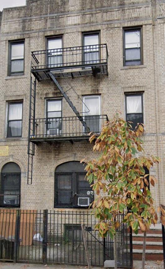 View of property featuring a fenced front yard
