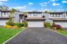 Contemporary facade with a single-car garage and asphalt driveway