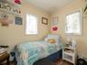 Bedroom featuring ornamental molding and wood finished floors
