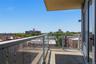 Private balcony with a concrete floor, glass railing, and aluminum frame