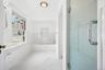 Bathroom with a bath and marble finish flooring