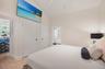 Primary bedroom with double closets and large screen TV