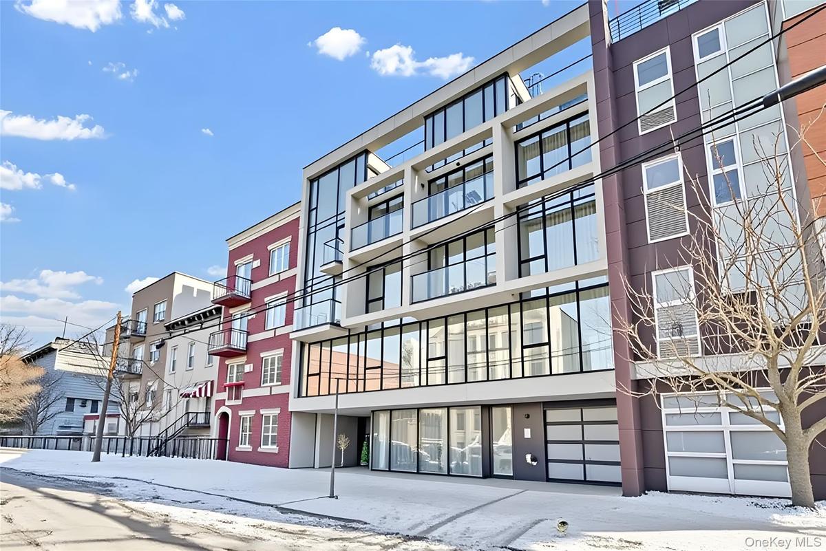 Snow covered property featuring a view of apartment building / complex