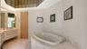 Soaking tub completes the primary bathroom, providing the perfect spot to unwind and relax