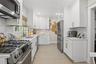 Beautifully renovated kitchen with stainless steel appliances and tiled backsplash (#220)