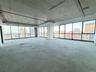 Empty room with a view of city and unfinished concrete floors