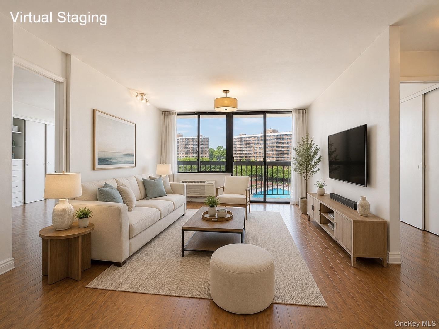 Sun-filled and spacious living room featuring desirable southern exposure, new windows, and updated heating/AC systems. Enjoy open views overlooking t