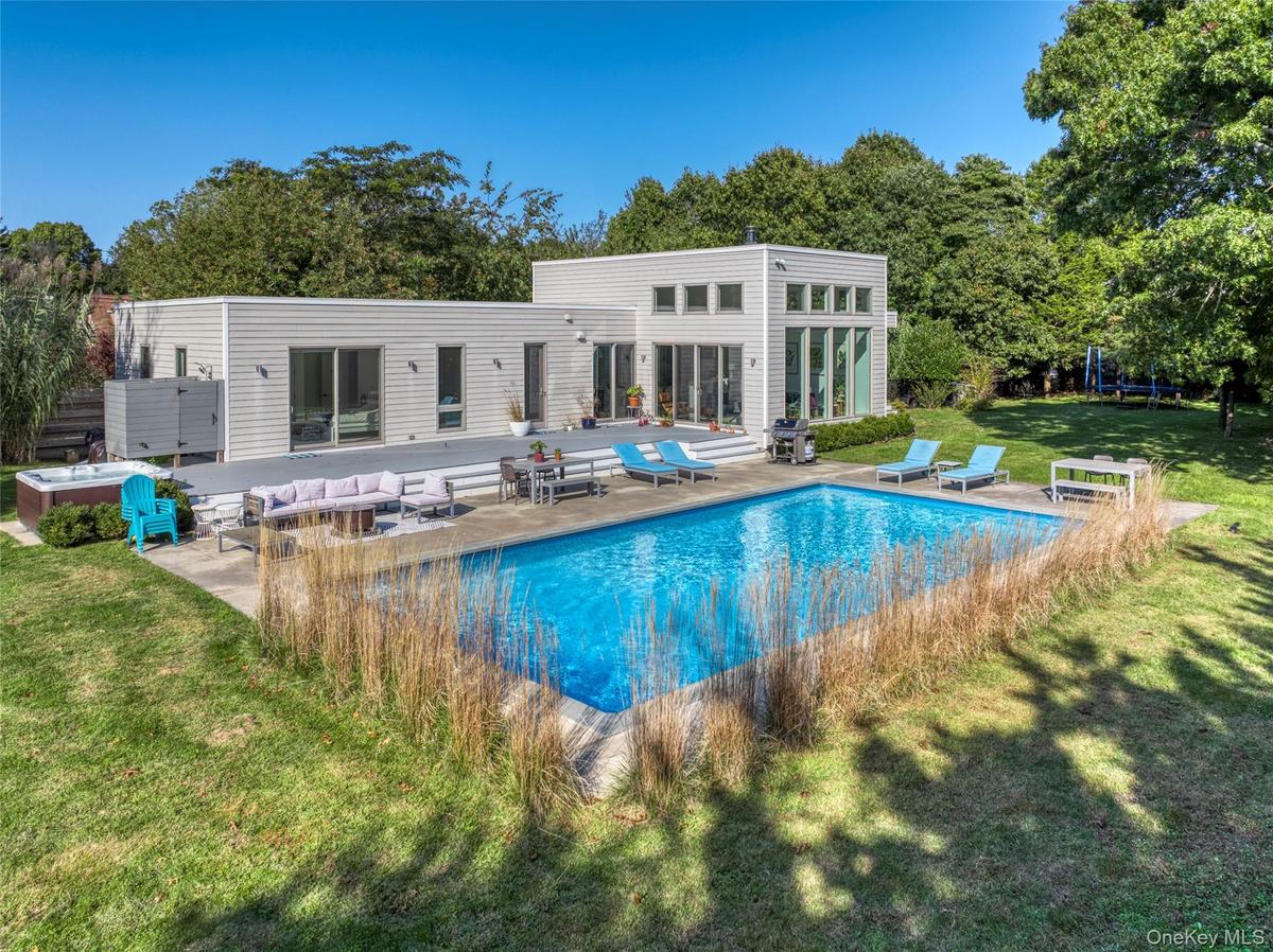 View of pool with outdoor lounge area, a patio area, a yard, and grilling area