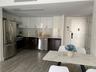 Kitchen with white cabinets, stainless steel appliances, modern cabinets, and backsplash