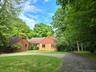 A circular driveway introduces this contemporary ranch