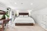 Primary bedroom with built in dressers and brand new oversized pella windows