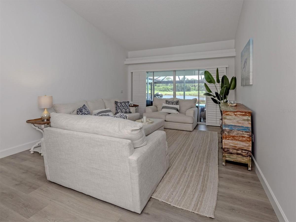 The formal living room includes sliding glass doors that open to the lanai