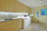 The expansive laundry and utility room provides abundant storage, workspace, and convenient access to the driveway and parking court.