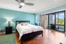 Primary suite with sliding doors to private screen enclosed balcony