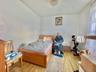 Bedroom featuring light wood-type flooring and baseboards