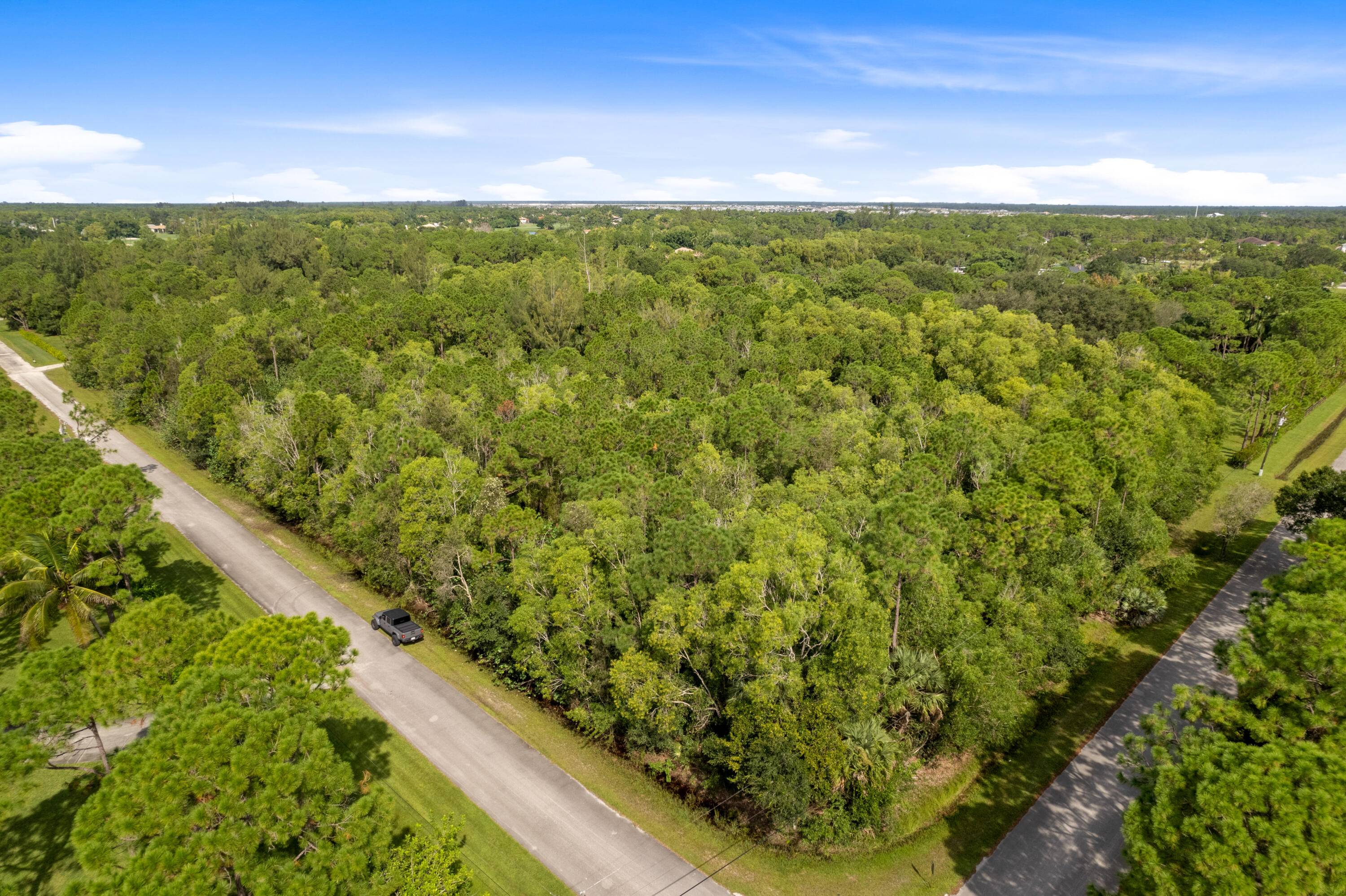 This beautiful 5 acre equestrian parcel is a CORNER lot located with two paved roads.