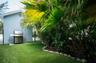The side yard just off the kitchen and dining area provides a great space for grilling