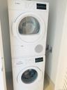 Laundry area featuring stacked washer and clothes dryer
