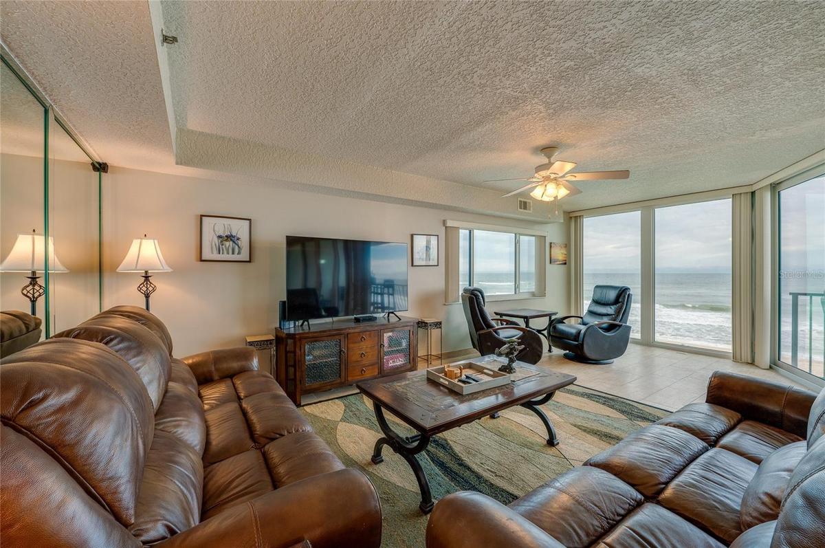 The living area features full-length windows with unobstructed ocean views and access to the balcony an ideal setting for relaxing or hosting guests.