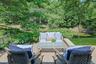 An elevated terrace off of the living room and overlooking the pond offers the perfect place to unwind and enjoy the peaceful setting.
