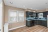 Kitchen featuring dark wood-finish cabinetry, and a full suite of appliances EIK