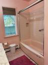 Bathroom with shower / bathtub combination, a baseboard radiator, tile patterned floors, and vanity