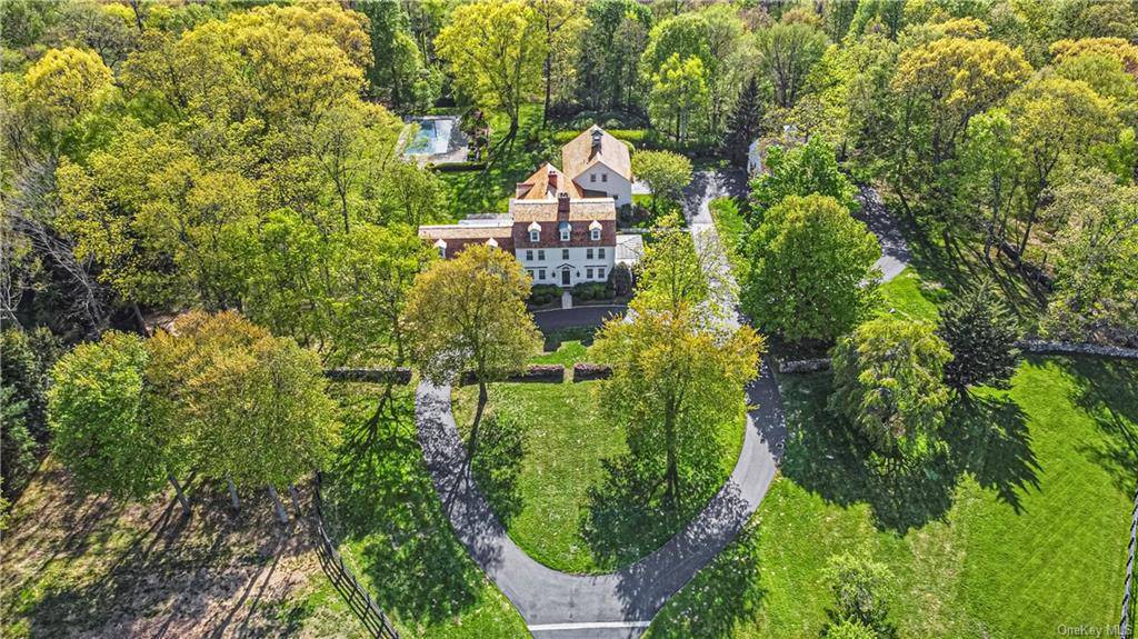 Idyllic setting within the private gates of exclusive Conyers Farm Association in Greenwich, Connecticut, this expansive colonial is set on fifteen private park like acres.