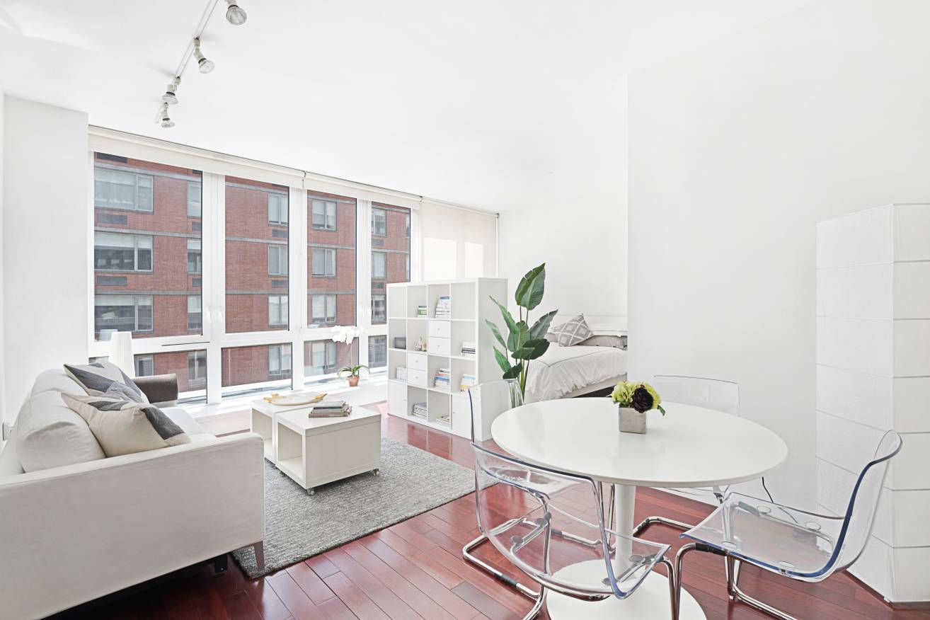 This spacious, light filled alcove studio convertible to a junior one bedroom with cherry wood floors, high ceilings and an enormous wall of windows facing south is located in The ...