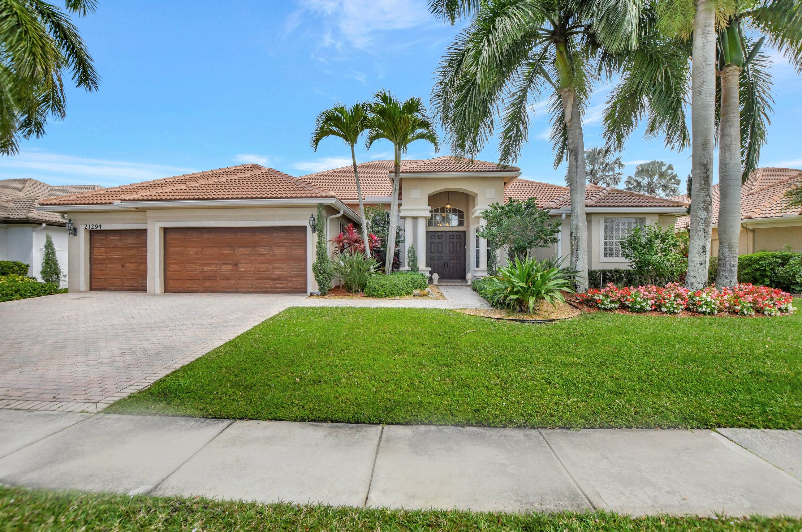 Beautiful one story single family home located within the security gates of the Estates Section of Boca Falls.