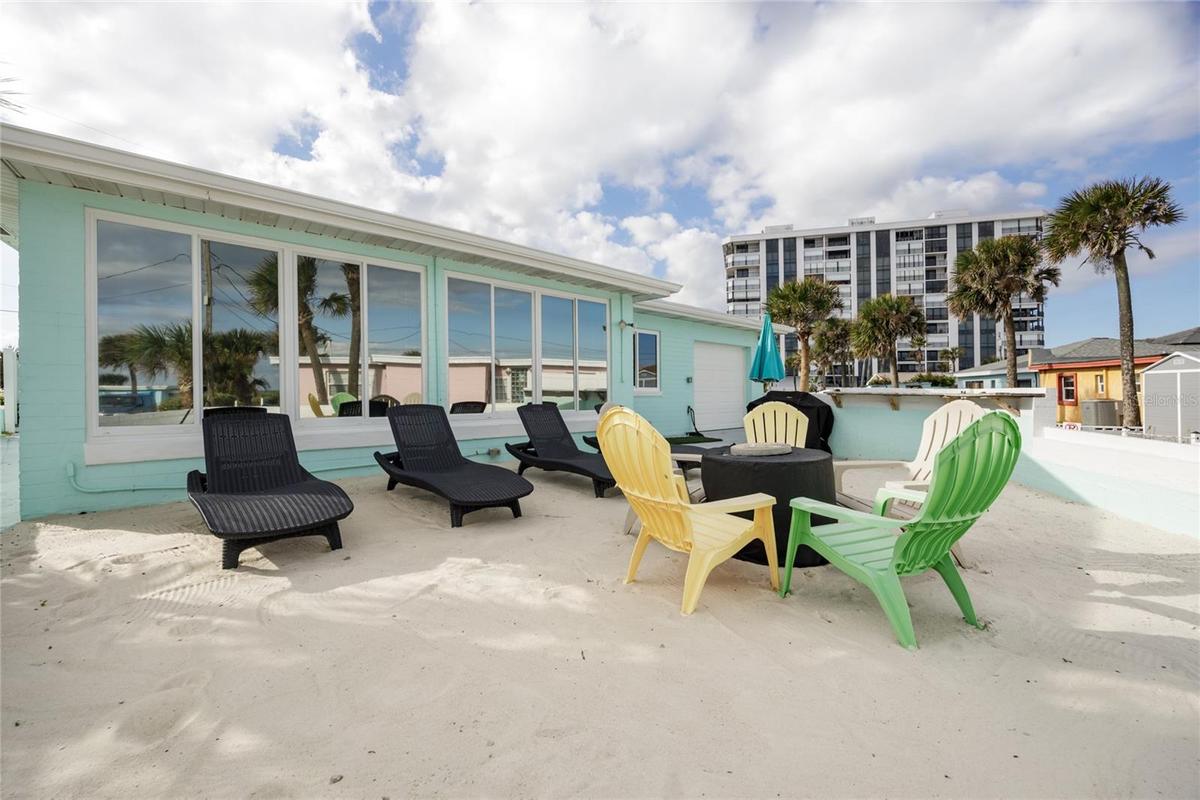Back yard with beach sand, beach view, grill, and bar top