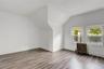 Bonus room with lofted ceiling, radiator heating unit, and wood finished floors