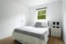 Bedroom with baseboards and wood-type flooring