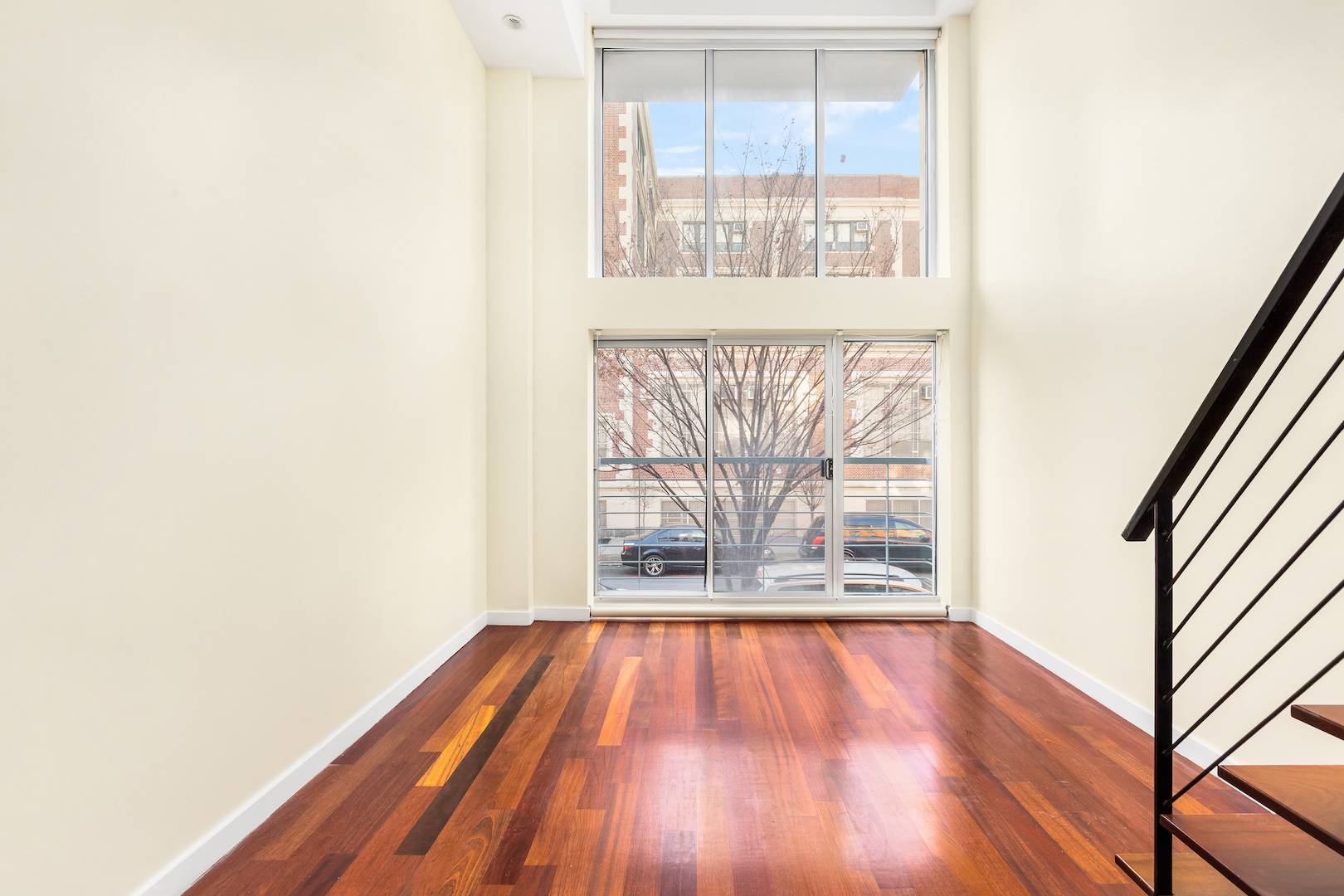 Welcome to Warren Lofts Apartment 201, an airy duplex residence with south facing floor to ceiling windows, cantilevered staircase, 14' 7 ceiling and cherry wood floors.