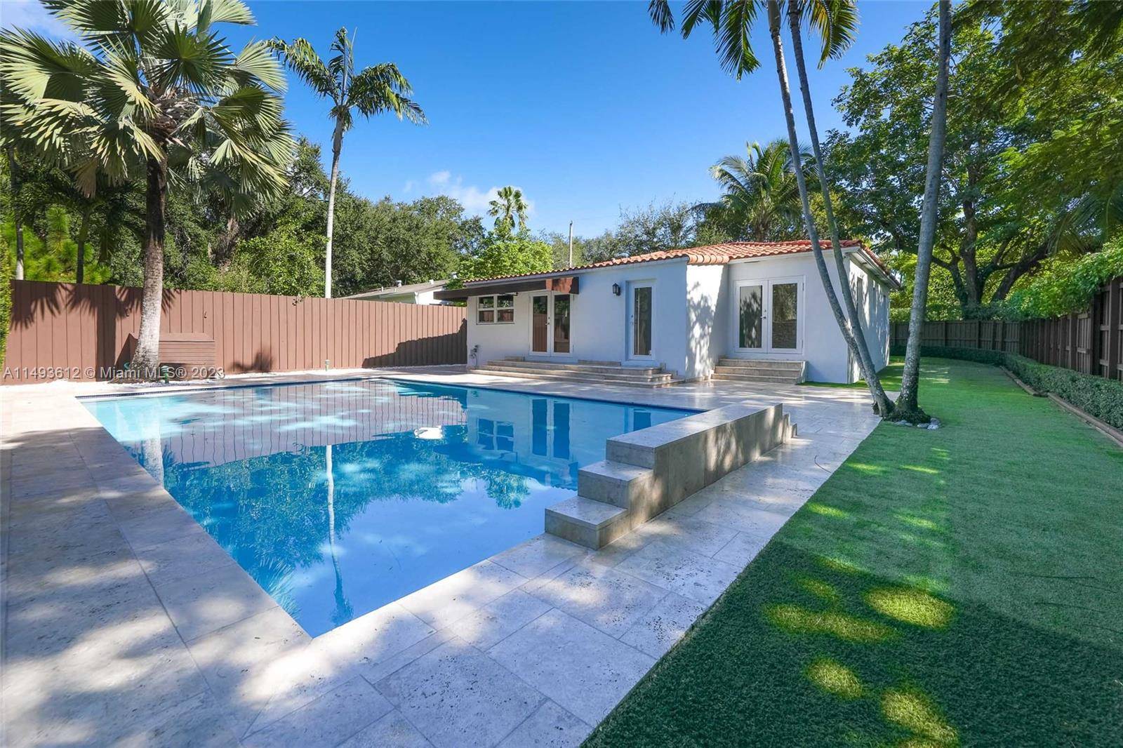 Indulge in the epitome of upscale living with this meticulously designed single family residence in North Coconut Grove.