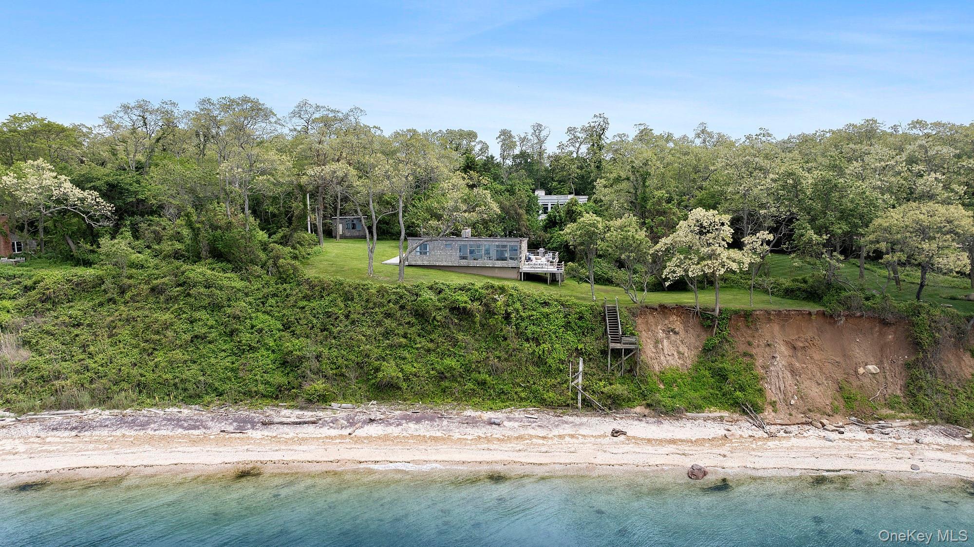 Aerial view of property and surrounding area with a nearby body of water