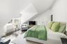Second Floor Bedroom with vaulted ceiling, wood finished floors, and a closet