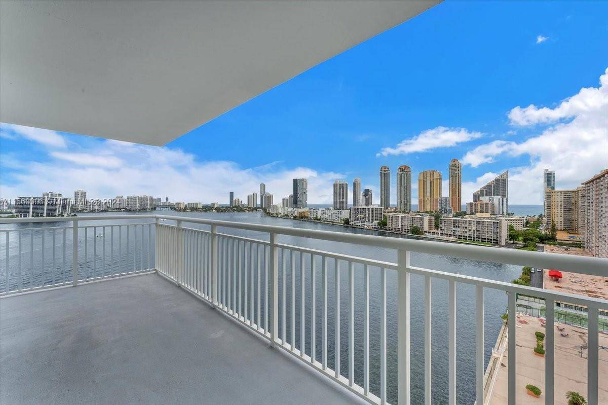 Welcome to this stunning corner unit offering breathtaking panoramic views of the bay, intercoastal ocean.