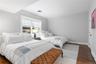 Bedroom with baseboards, visible vents, and dark wood-style flooring