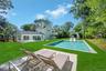 Outdoor pool featuring a patio area and a lawn