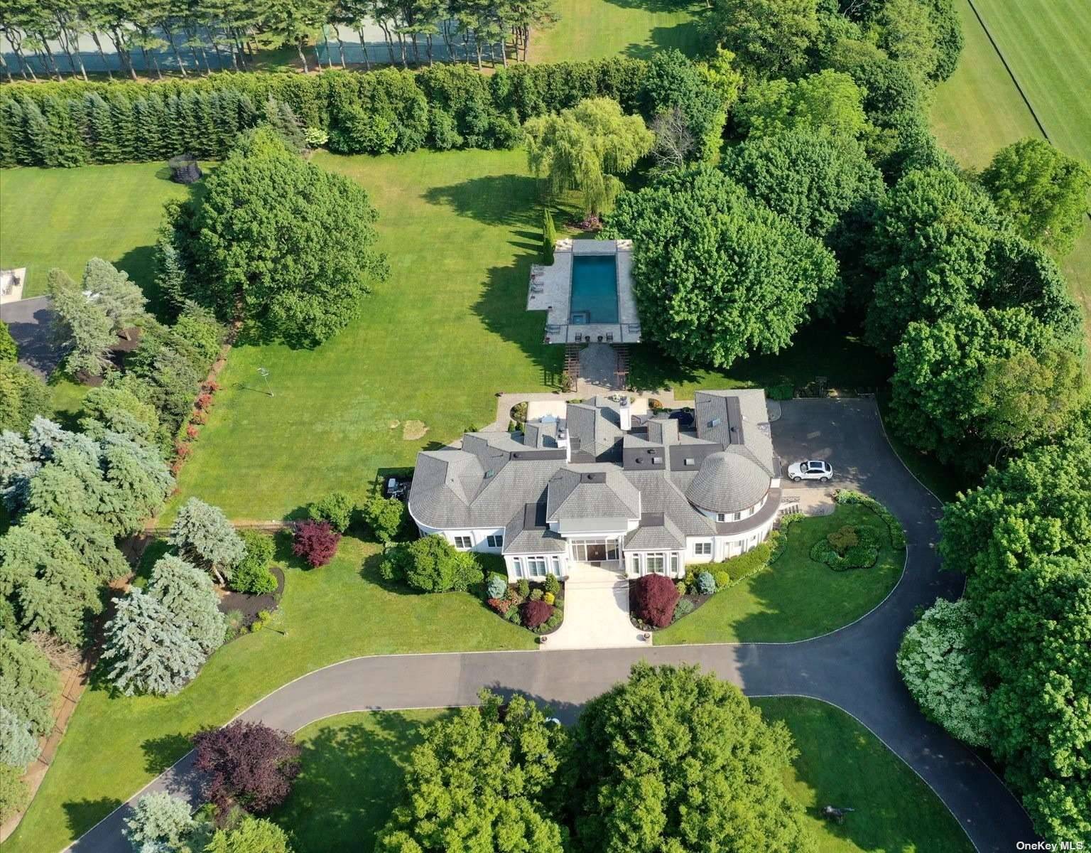 Major Tax Reduction ! Welcome to 4 Polo Drive, a spectacular estate located in the sought after Old Westbury community.
