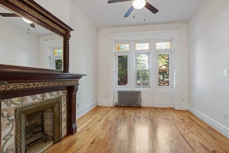 Sitting on a wide street is a 4 storied Renaissance Revival brownstone replete with pre war period details of 1899, including stained glass transom over first floor windows, historic wood ...