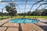 Expansive Covered & Screened Lanai with Paver Pool Deck