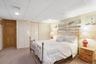 Carpeted bedroom with a closet, a paneled ceiling, and recessed lighting