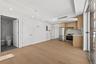Kitchen with modern cabinets, appliances with stainless steel finishes, recessed lighting, light wood-type flooring, and open floor plan