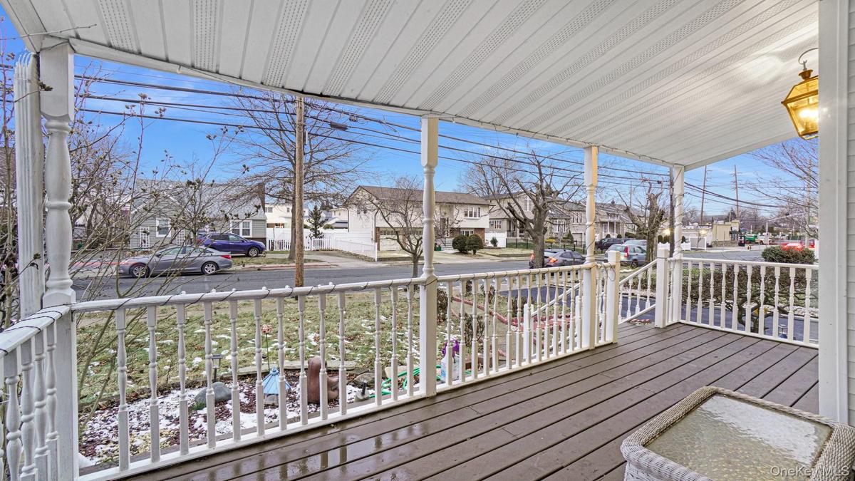Wooden terrace featuring covered porch and a residential view